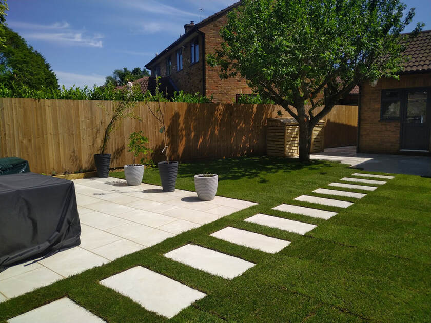 Modern porcelain patio with stepping stones in lawn